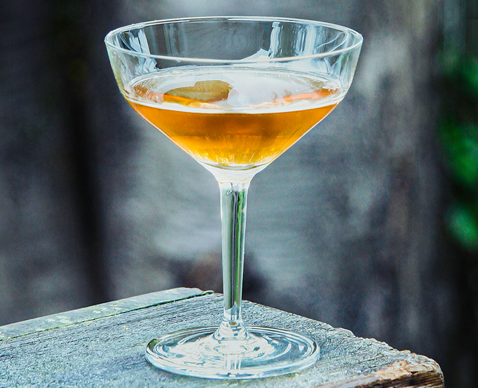 The Adonis Amontillado Sherry Cocktail on a piece of wood